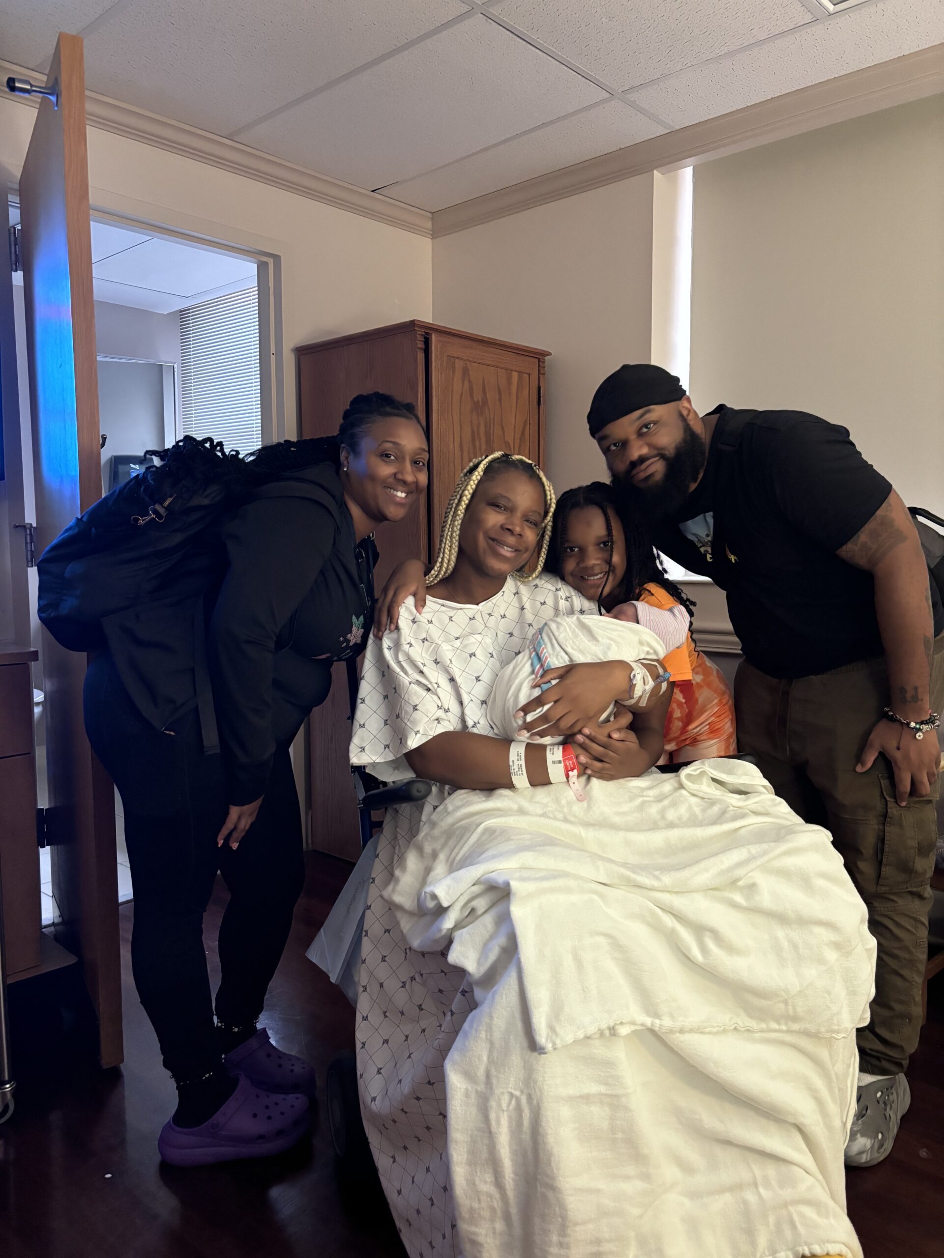 Bonita with a joyful family after birth