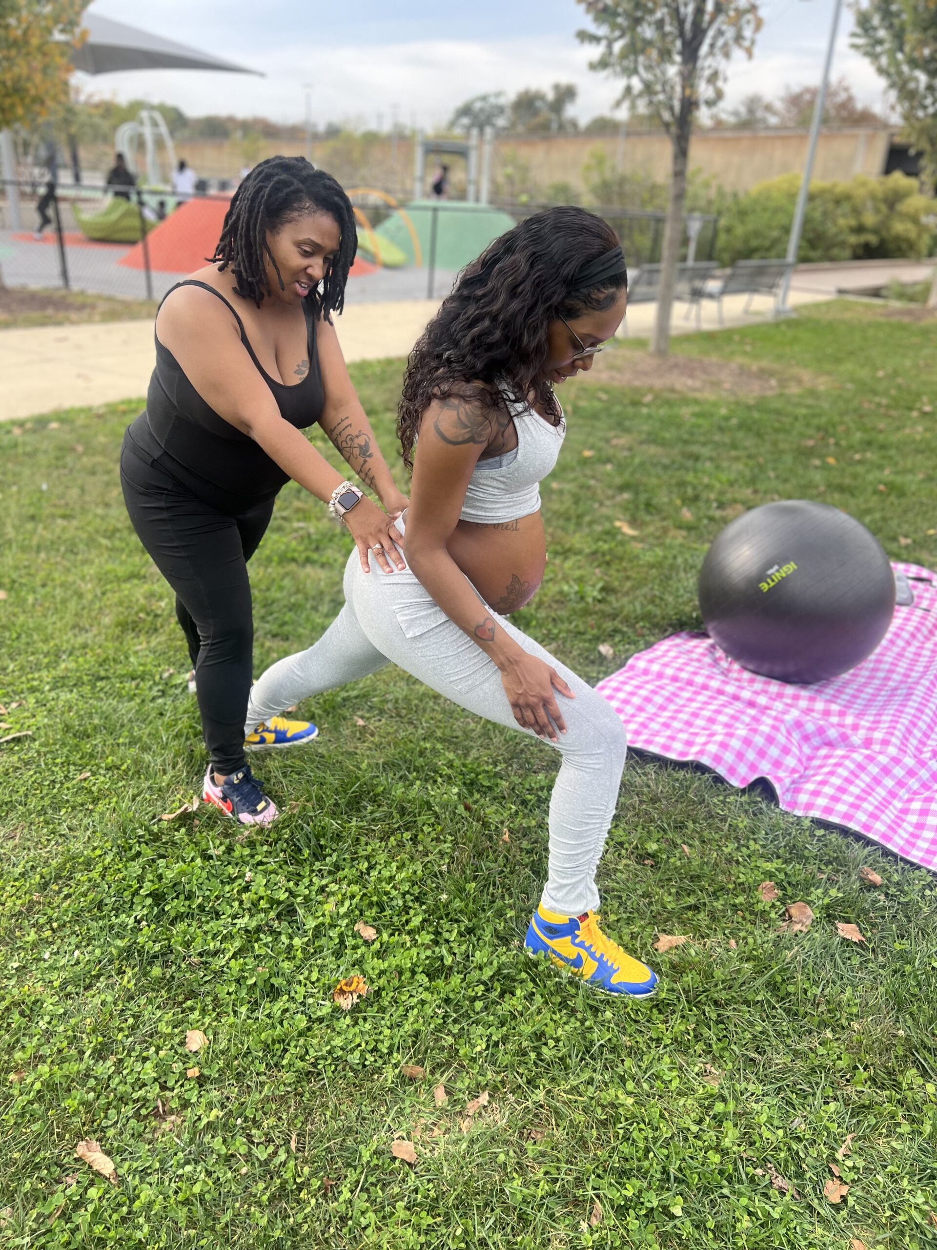 Bonita supporting a pregnant client outdoors